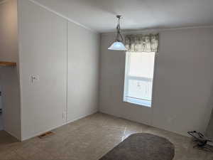 Unfurnished dining area featuring crown molding