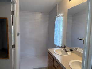 Bathroom with double vanity and elevator