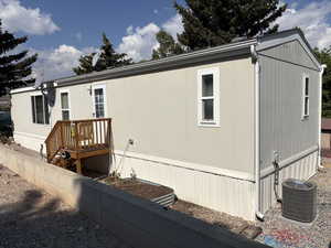 View of side of home featuring a central AC unit