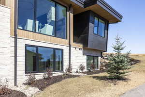 View of property exterior featuring stone siding