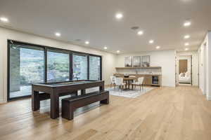 Dining space featuring billiards, light wood-style flooring, recessed lighting, and wine cooler