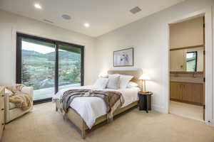 Bedroom with carpet floors, access to exterior, ensuite bath, and recessed lighting