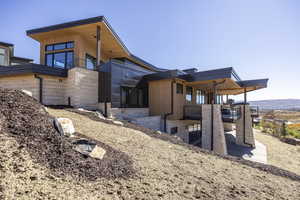 View of home's exterior with a patio area and stairs