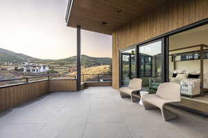 Balcony at dusk featuring a patio and a mountain view