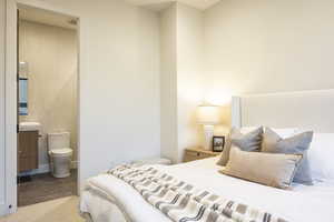 Tiled bedroom featuring tile walls