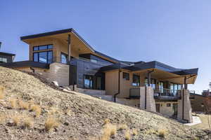 View of side of home featuring a patio area and a balcony