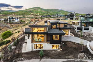 Rear view of house featuring a mountain view, a metal roof, and driveway