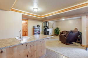 Kitchen featuring light colored carpet, light tile patterned flooring, light brown cabinetry, and open floor plan