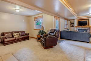 Living area with a fireplace and light colored carpet
