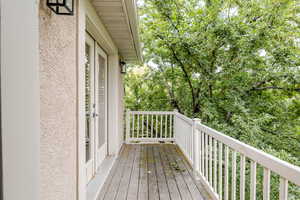 Wooden deck featuring view of wooded area
