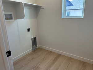 Laundry area featuring light wood-style floors, electric dryer hookup, and washer hookup