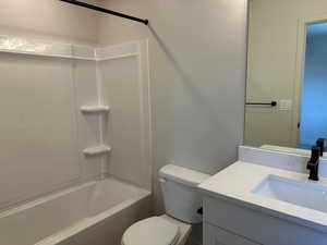 Full bath featuring vanity and bathing tub / shower combination
