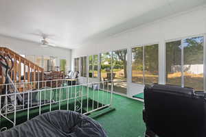 Sunroom / solarium featuring a ceiling fan