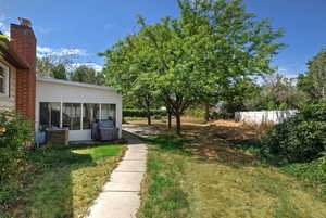 View of yard featuring a sunroom