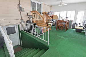 View of playground with a sunroom and ceiling fan