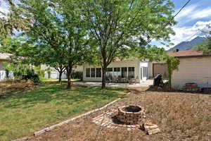 Back of property featuring a patio and an outdoor fire pit