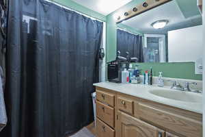 Bathroom featuring vanity and a shower with shower curtain