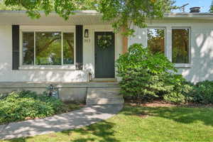 Property entrance featuring brick siding and a porch