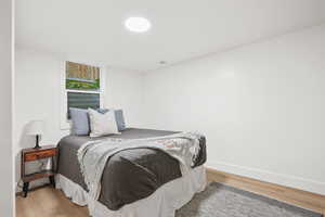 Bedroom featuring wood finished floors and baseboards