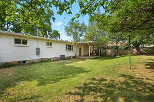 Rear view of house featuring a patio and brick siding