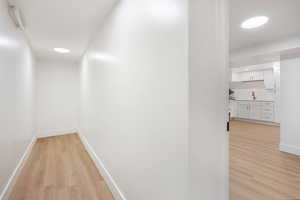 Hallway with light wood-style floors