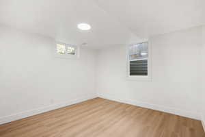 Basement with light wood-style flooring