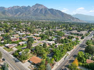 Aerial overview of property's location with mountains and nearby suburban area