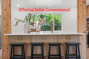 Bar with light stone countertops and stainless steel range oven