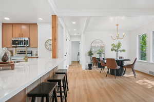 Dining space featuring light wood-style flooring, recessed lighting, and a chandelier