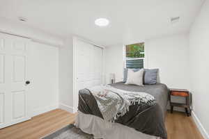 Bedroom featuring light wood-style floors and a closet