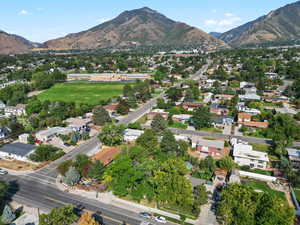 Aerial view of property's location with a mountainous background and nearby suburban area