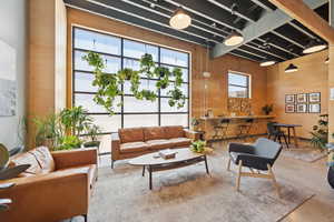 Common area with wood walls and a towering ceiling