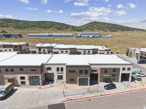 View of front of property with a mountain view and uncovered parking