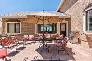 View of patio with a grill and outdoor lounge area