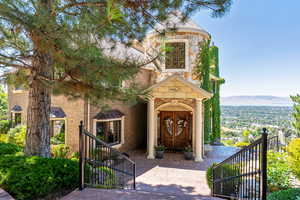 Entrance to property featuring stone siding, brick siding, a mountain view, and french doors