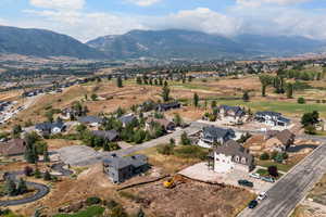 Aerial overview of property's location with nearby suburban area and a mountain backdrop