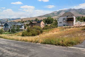 View of mountain backdrop featuring nearby suburban area