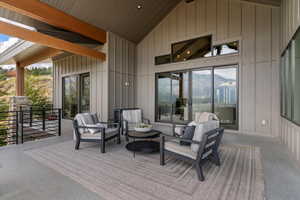 Wooden terrace featuring a patio area and an outdoor living space