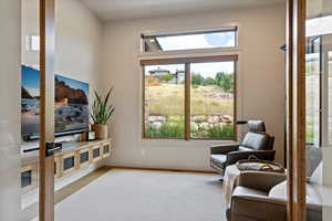 Living area featuring baseboards and wood finished floors