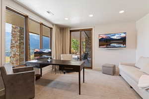 Carpeted office featuring recessed lighting