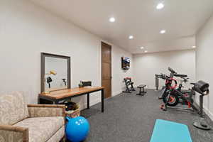 Workout room with recessed lighting and baseboards