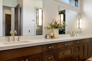 Bathroom with double vanity and a stall shower