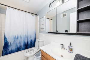 Bathroom with vanity and a wainscoted wall