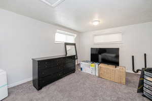 Interior space with carpet floors and a textured ceiling