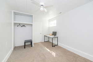 Unfurnished bedroom with light carpet, ceiling fan, and a closet
