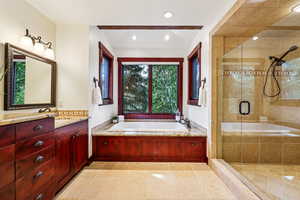 Full bathroom with vanity, a shower stall, a garden tub, recessed lighting, and light tile patterned floors