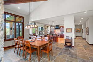 Dining space with beamed ceiling, recessed lighting, and high vaulted ceiling