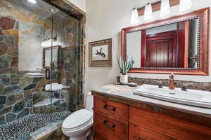 Full bathroom with vanity and a shower stall