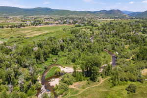 Aerial view of property and surrounding area with mountains