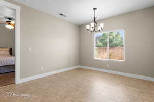 Unfurnished dining area featuring a chandelier and light tile patterned flooring